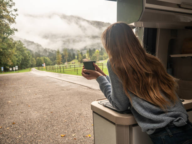 istock Woman enjoys coffee from her van 1312456621