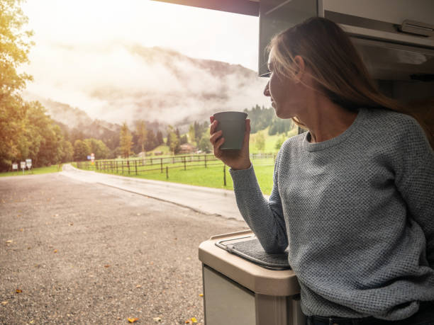 istock Woman enjoys coffee from her van 1312456622