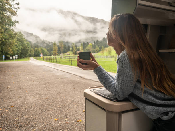 istock Woman enjoys coffee from her van 1312456633