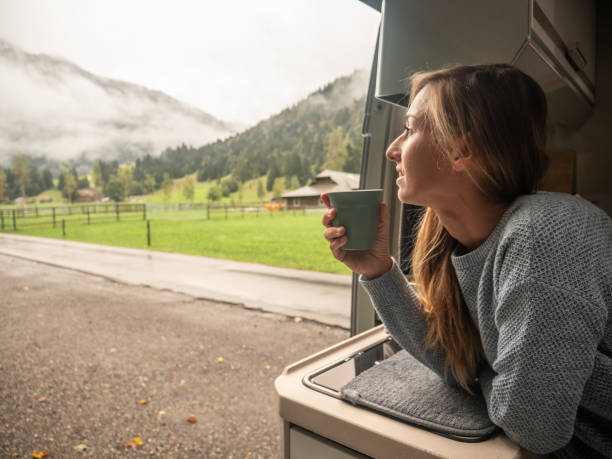 istock Woman enjoys coffee from her van 1312456653