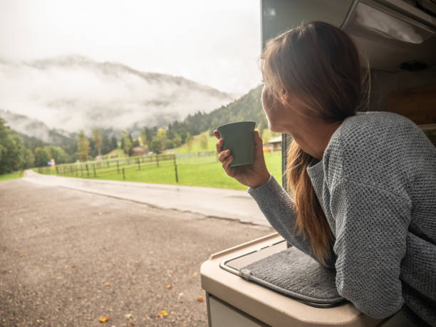 istock Woman enjoys coffee from her van 1312456698