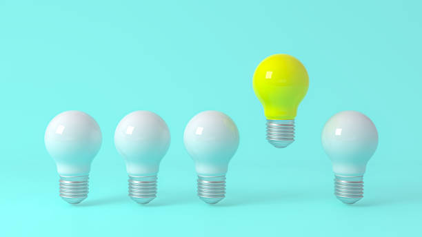 istock 3D Scene. A yellow light bulb is above the blue light bulb. 1312458050