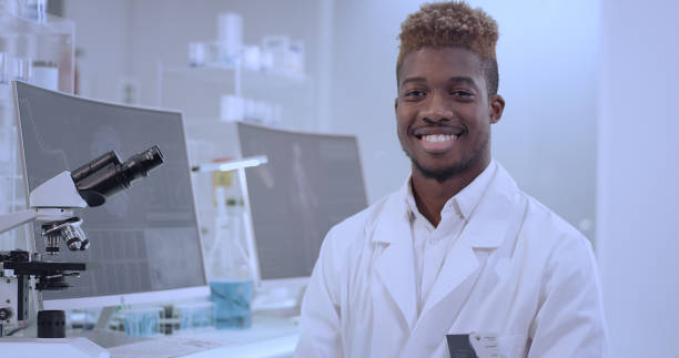 istock African doctor in laboratory. Satisfied with his work. Smiling to a camera 1312459134