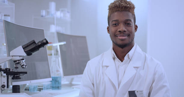 istock African doctor in laboratory. Satisfied with his work. Smiling to a camera 1312459146