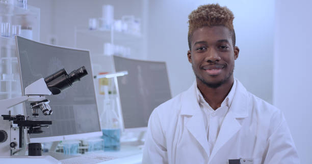istock African doctor in laboratory. Satisfied with his work. Smiling to a camera 1312459232