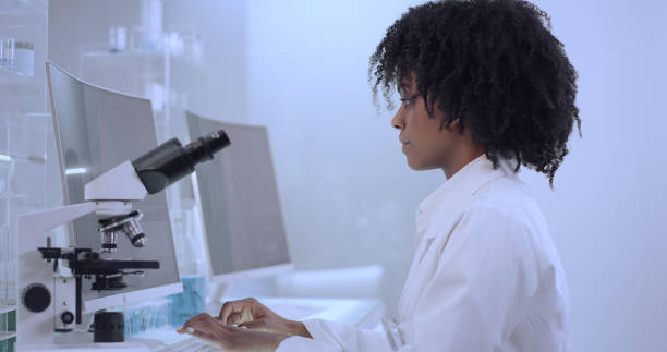 istock African ethnicity, female doctor using microscope in laboratory. 1312459258