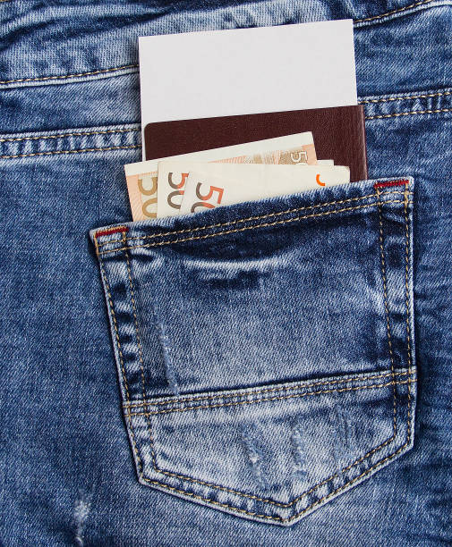 Immunity passport with money in jeans pocket.