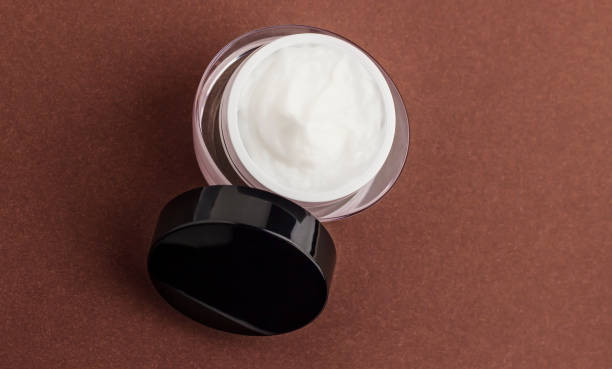 istock Jar with a hair mask on a brown background. 1312461265
