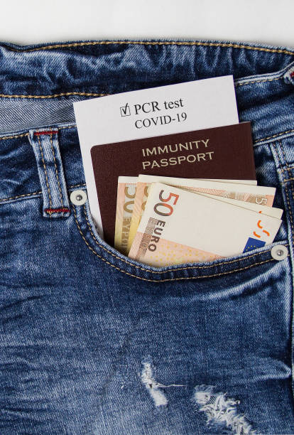 istock Immunity passport with money in jeans pocket. 1312461377
