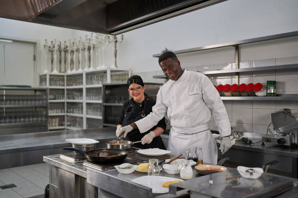 istock Behind your delicious meal, standing two professional chefs, making every dish with a big smile 1312465626