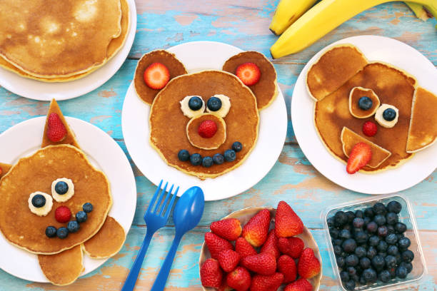 Fun food for children. Set of plates with funny pancakes. Creative idea for kids breakfast. stock photo