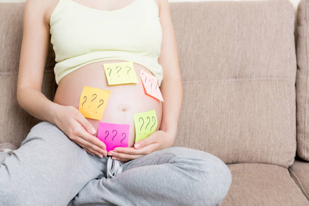istock Pregnant woman belly with question mark. Pregnancy and thinking problem 1312466986