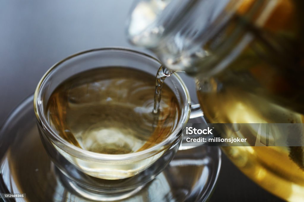 Healthy and relaxing hot drink with a mixture of linden, sage, lemon slice, green tea, thyme Herbal Tea Stock Photo