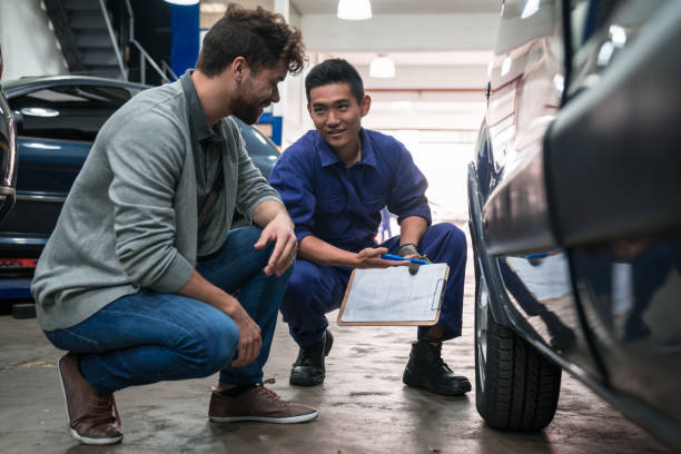 istock Car mechanic checking wheel in garage 1312469458
