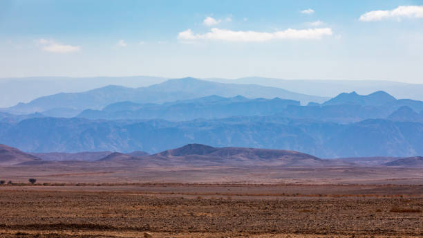 Distant mountains in the morning haze in the desert Distant mountains in the morning haze in the Arava desert on the road to Eilat in Israel heat haze stock pictures, royalty-free photos & images
