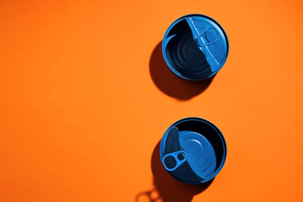 istock Aesthetic concept with blue painted tin can on orange background 1312470662