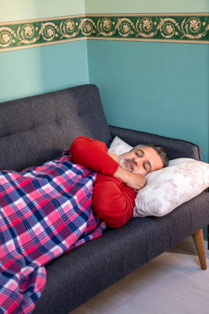 istock Sick man asleep in bed as day 1312472469