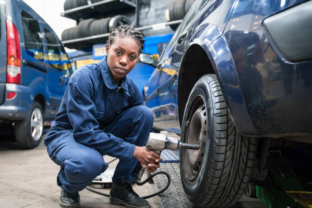 istock Female car mechanic changing wheel 1312473594