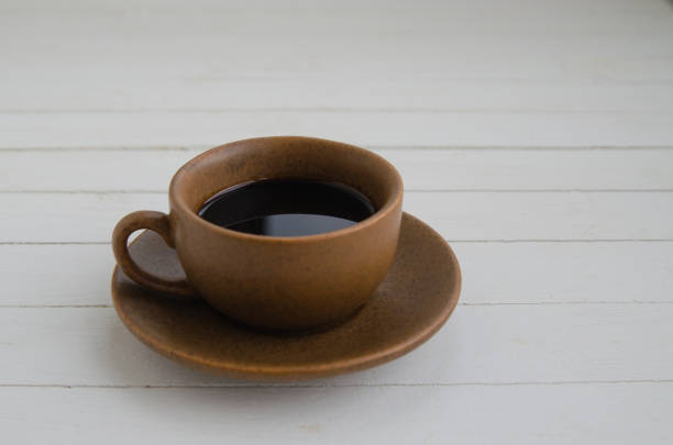 istock Black coffee with drops in a brown cup 1312473934