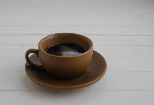istock Black coffee with drops in a brown cup 1312473941