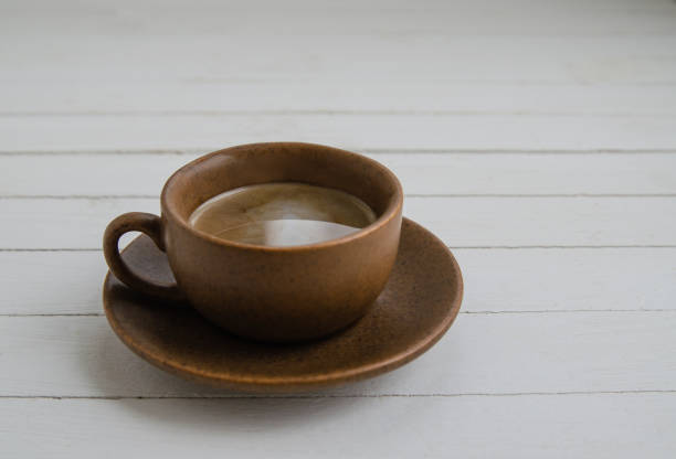istock Black coffee with drops in a brown cup 1312473948