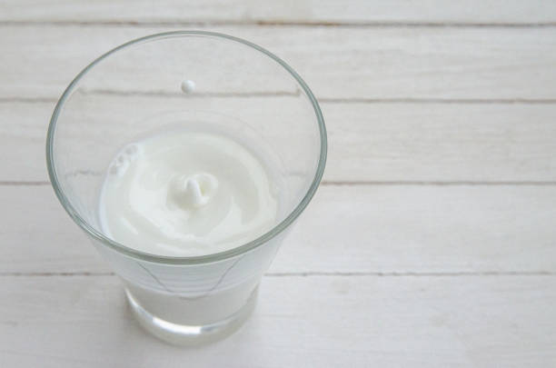 istock White cow's milk in a clear glass on a light background 1312473961