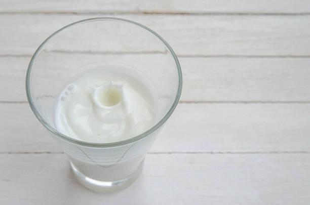 istock White cow's milk in a clear glass on a light background 1312473986