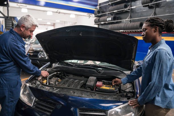 istock Female customer talking with car mechanic 1312473991