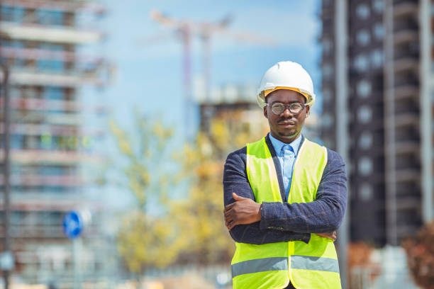 istock Architect at building site with folded arms looking at camera. 1312474550
