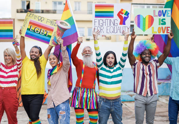 istock Multiracial gay people from different generations having fun at lgbt pride parade - Concept of homosexual and transgender love 1312475091