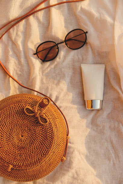 Beautiful female accessories, glasses and cream on the beach. Summer vacation resort Beautiful female accessories, glasses and cream on the beach. Summer vacation resort beach bag stock pictures, royalty-free photos & images