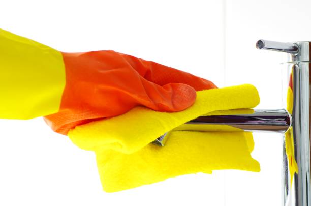 istock Woman cleans faucet 1312476529