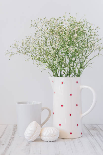 bodegón un jarrón de flores una taza con una bebida caliente y dulces sobre un fondo ligero - 6646 fotografías e imágenes de stock