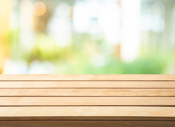 istock Selective focus.wood table top on blur abstract glass wall background. 1312478919