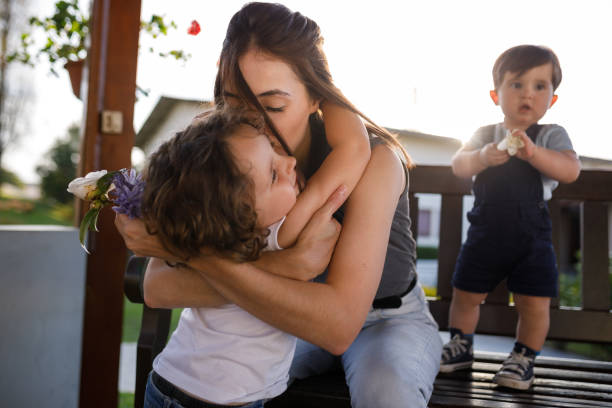 istock Mother hugging and kissing her little son 1312481693