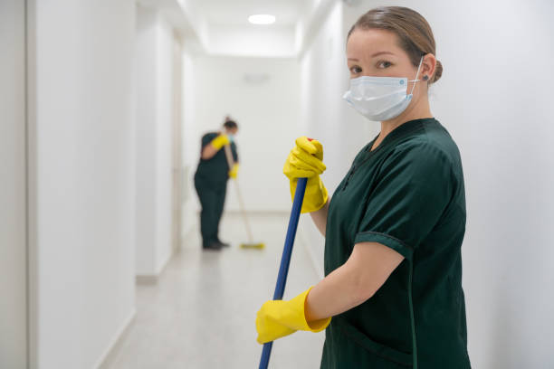 istock Cleaner wearing a facemask while working at an office building sweeping the floors 1312481795