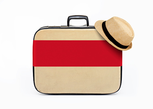Fedora hat on a retro luggage with a blank banner