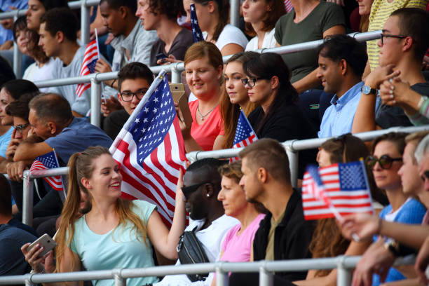 istock Crowd waving USA flags on a stadium 1312483277