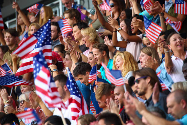 istock Crowd waving USA flags on a stadium 1312483294