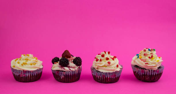 istock Various cream cupcakes on a pink background. The triumph of Copy space 1312485056
