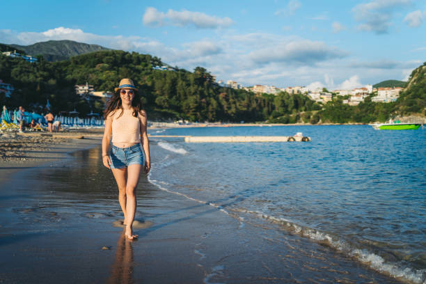 istock Young woman walking by a sea 1312485139