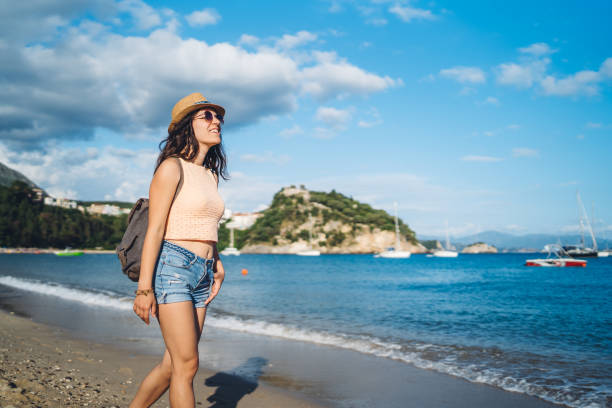 istock Young woman walking by a sea 1312485164