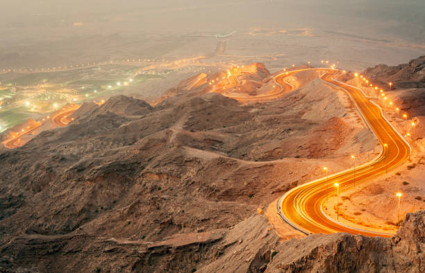Jebel Hafeet Mountain, Al Ain at night. Traffic descending Jebel Hafeet Mountain at night. jebel hafeet stock pictures, royalty-free photos & images