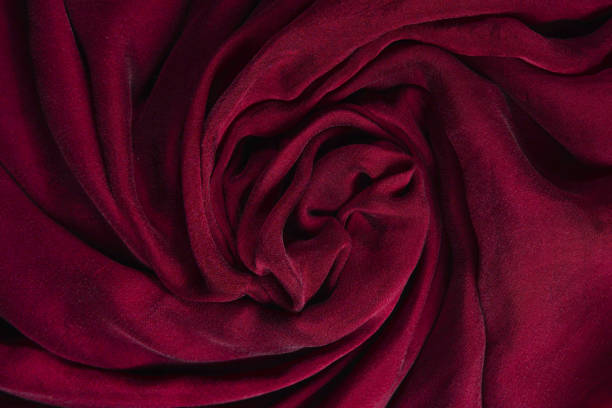 istock Soft smooth burgundy silk fabric background. Fabric texture. 1312490176