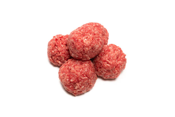 istock Raw meat balls isolated on white background. 1312490179