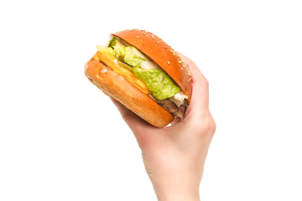 istock Hamburger in woman hands isolated on a white background. 1312490204