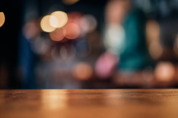istock Wood table top on of abstract blurred restaurant lights background 1312491095