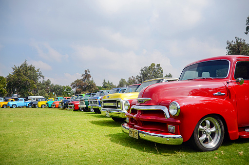 Mexico - September, 2018: Vintage car show and exhibition of Chevrolet pick-up trucks and chevy cars outdoors. Red chevy classic vehicle parked in a retro event.