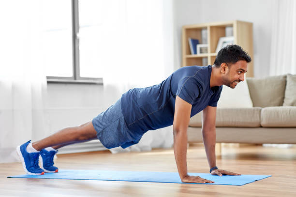 istock indian man doing push ups at home 1312492627