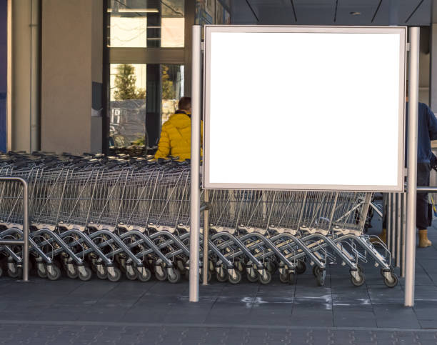 istock Blank billboard in a supermarket, next to shopping carts. 1312495224